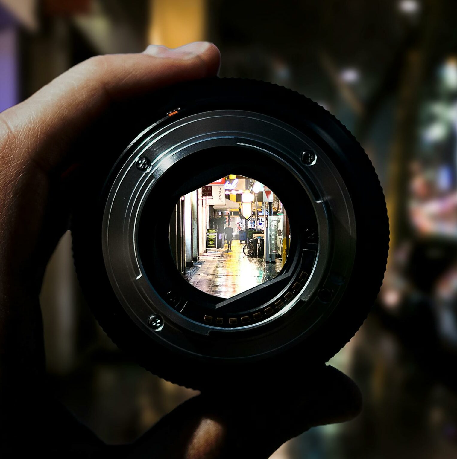 A unique perspective of Düsseldorf's city streets seen through a camera lens at night.