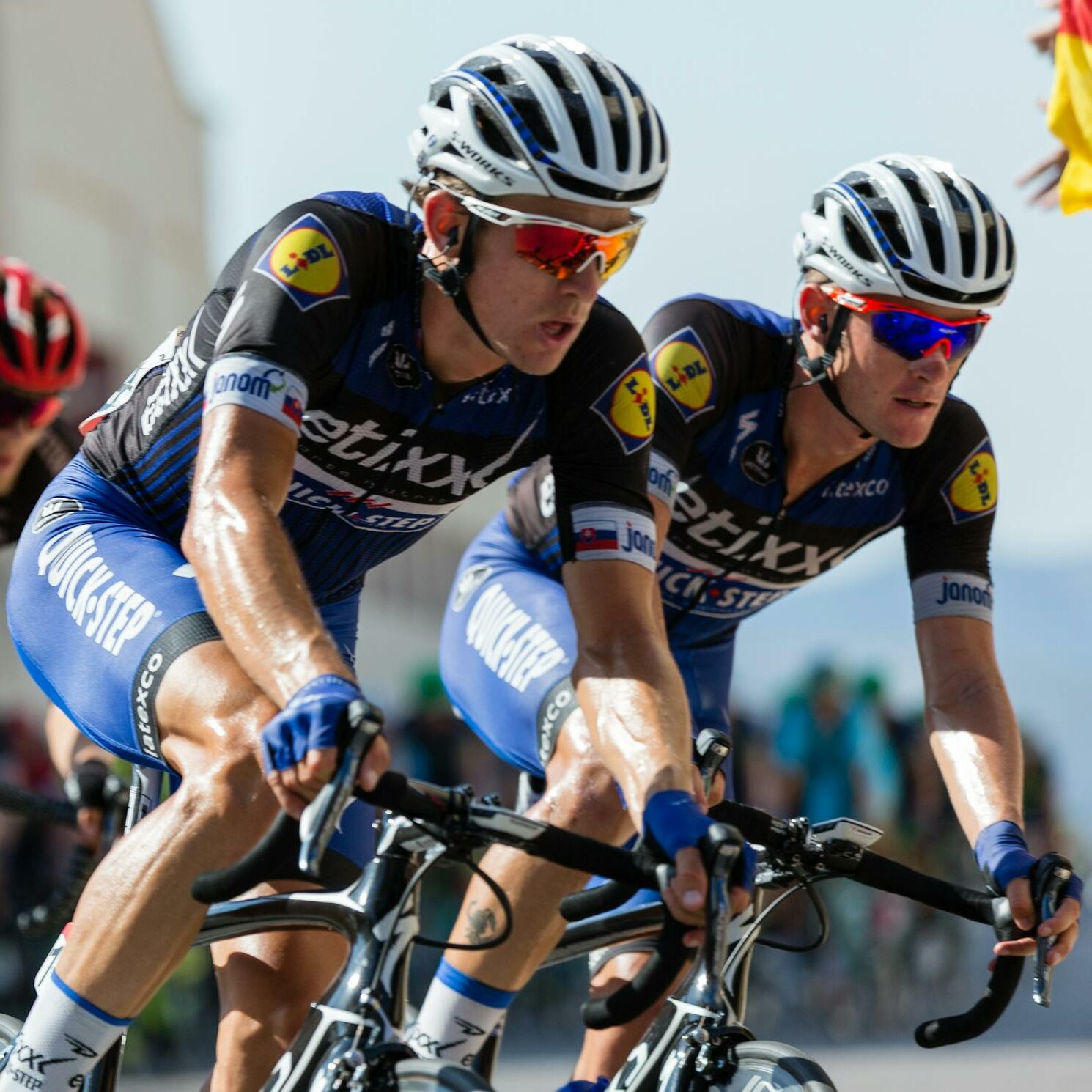 Competitive cyclists in a high-speed race, showcasing athleticism and teamwork.